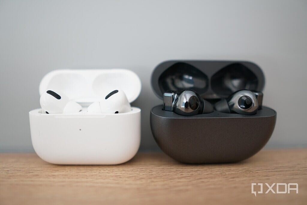 Apple AirPods Pro and Huawei FreeBuds Pro in case and on a table