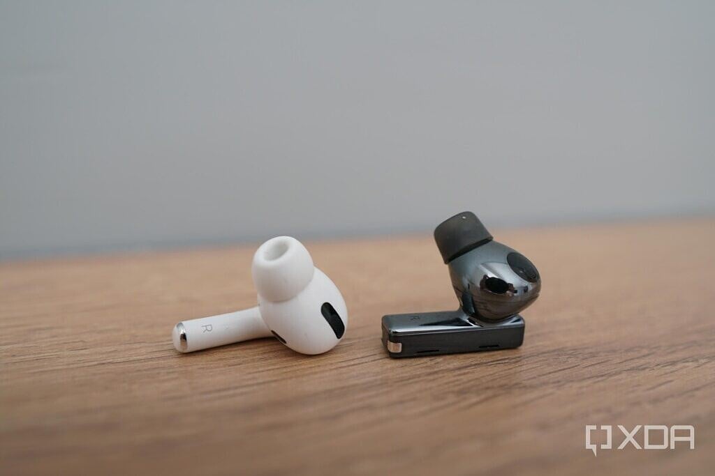 Earbud of Apple AirPods Pro and Huawei FreeBuds Pro on a table for comparison