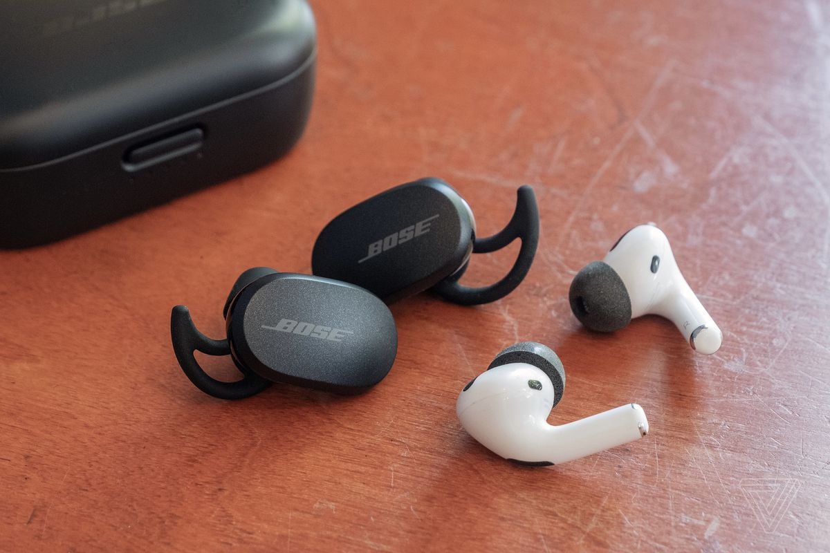 Bose’s QuietComfort Earbuds next to the Apple AirPods Pro.