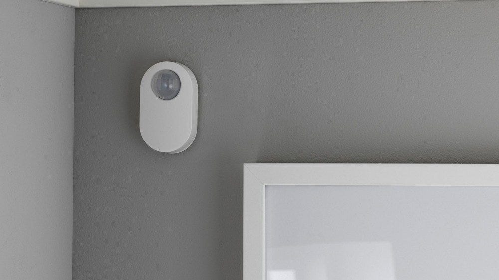 An IKEA Motion sensor in the corner of a room.