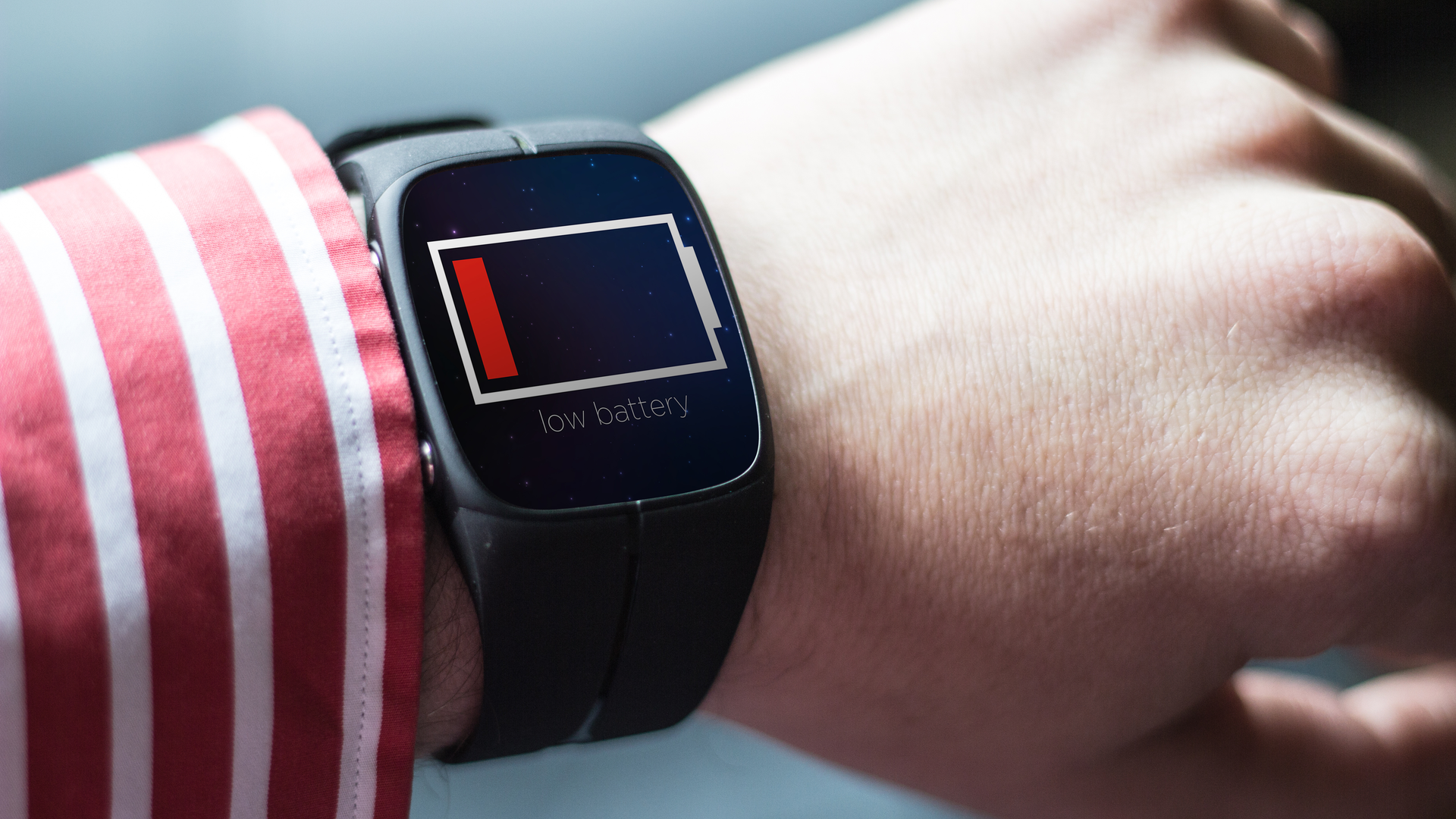 lifestyle concept: low battery smartwatch. Screen graphics are made up.