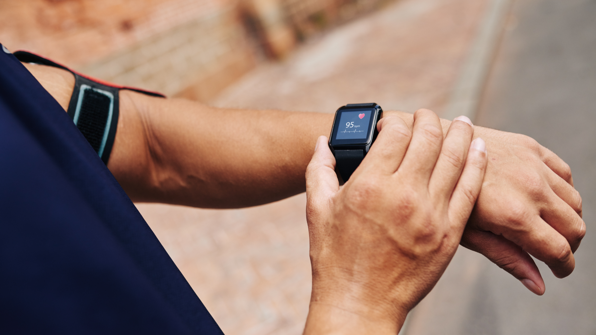 Close-up image of athlete checking their pulse on a smart watch