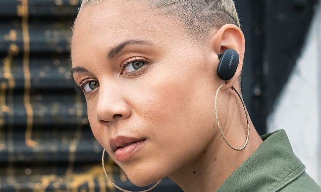 person wearing bose quietcomfort earbuds