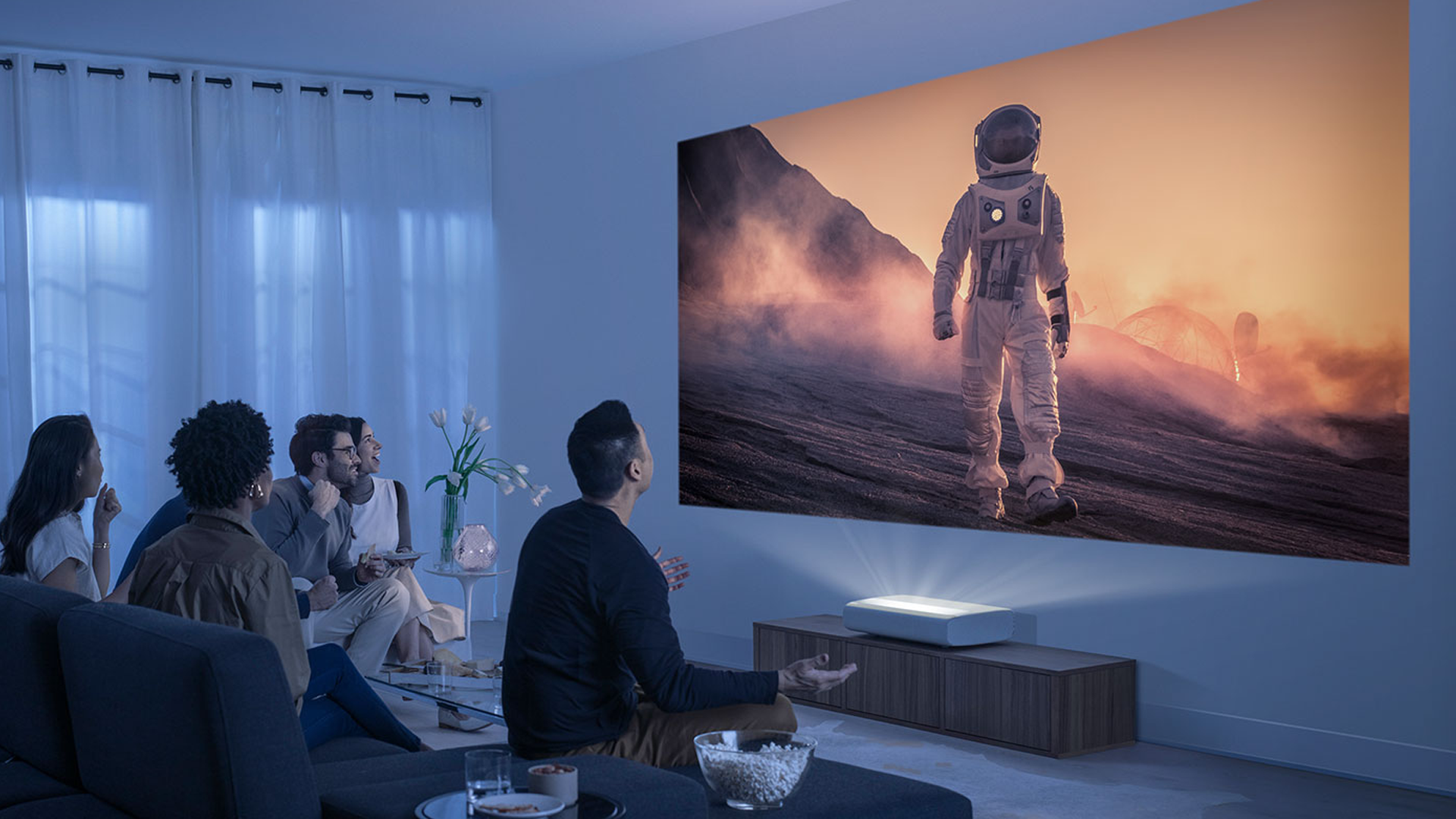 People watching a film with the Samsung Premiere ultra-short throw projector.