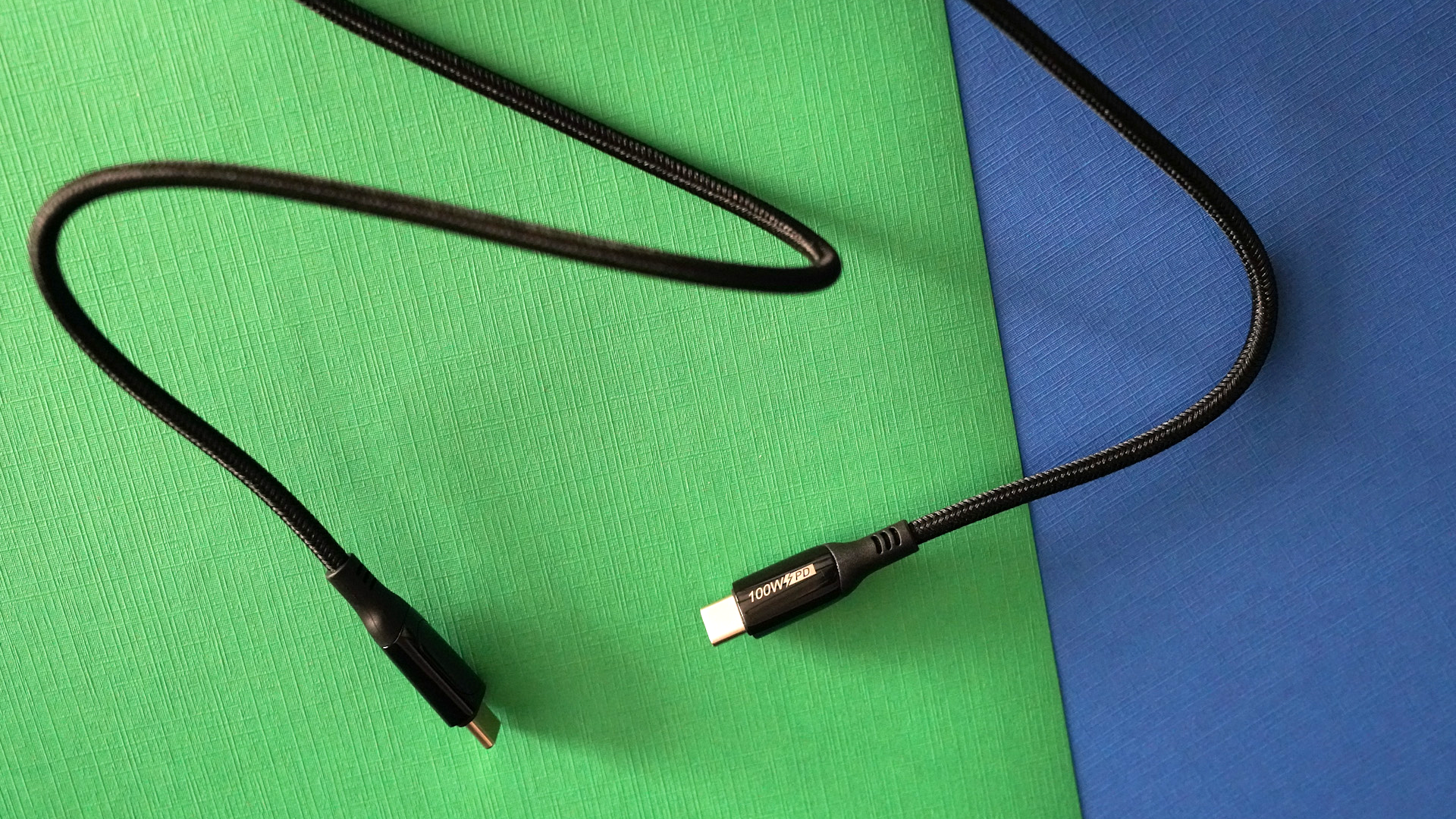 TheBoth ends of the Chipofy LED Power Display cable unplugged atop a colorful background