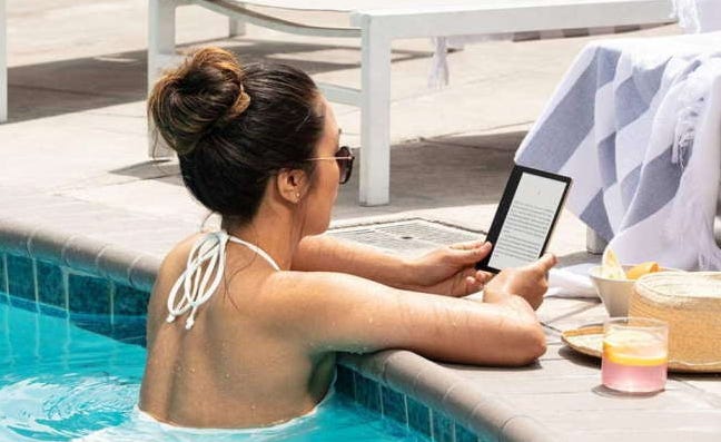 woman reading kindle in the pool