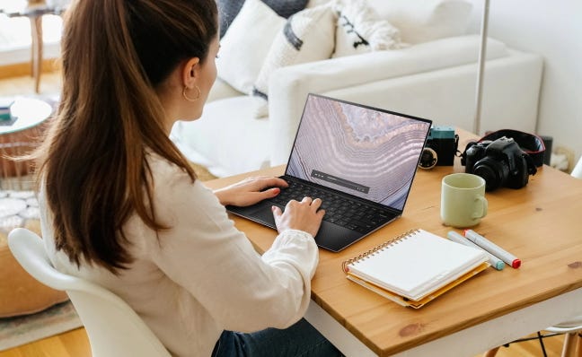 woman using dell xps 13 at home