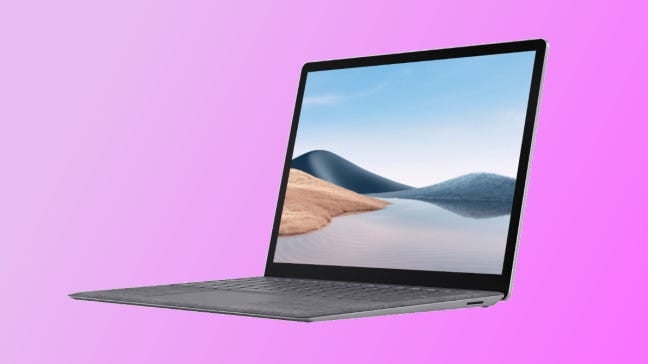 laptop de superfície em fundo rosa
