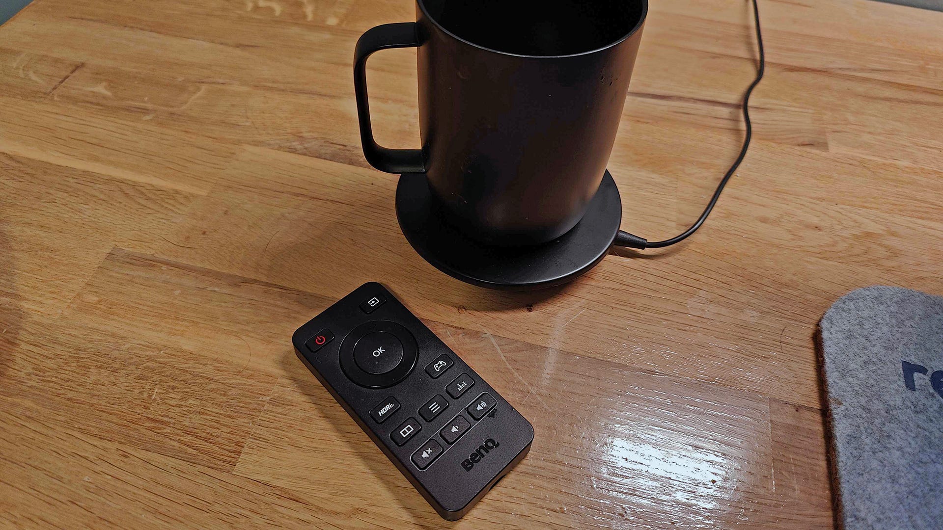 A tiny remote with controls for a monitor
