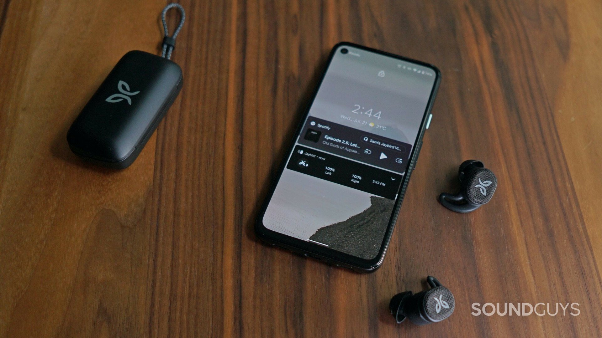 Jaybird Vista 2 earbuds and case next to smartphone.