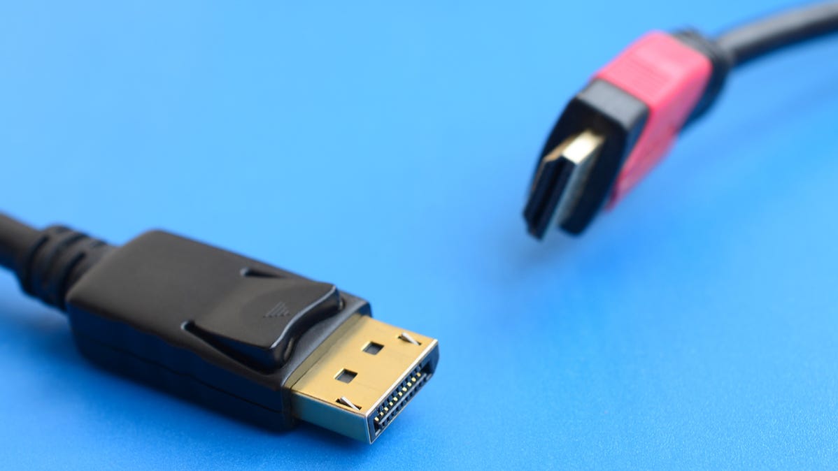 Closeup of a DisplayPort cable connector next to an HDMI cable connector.