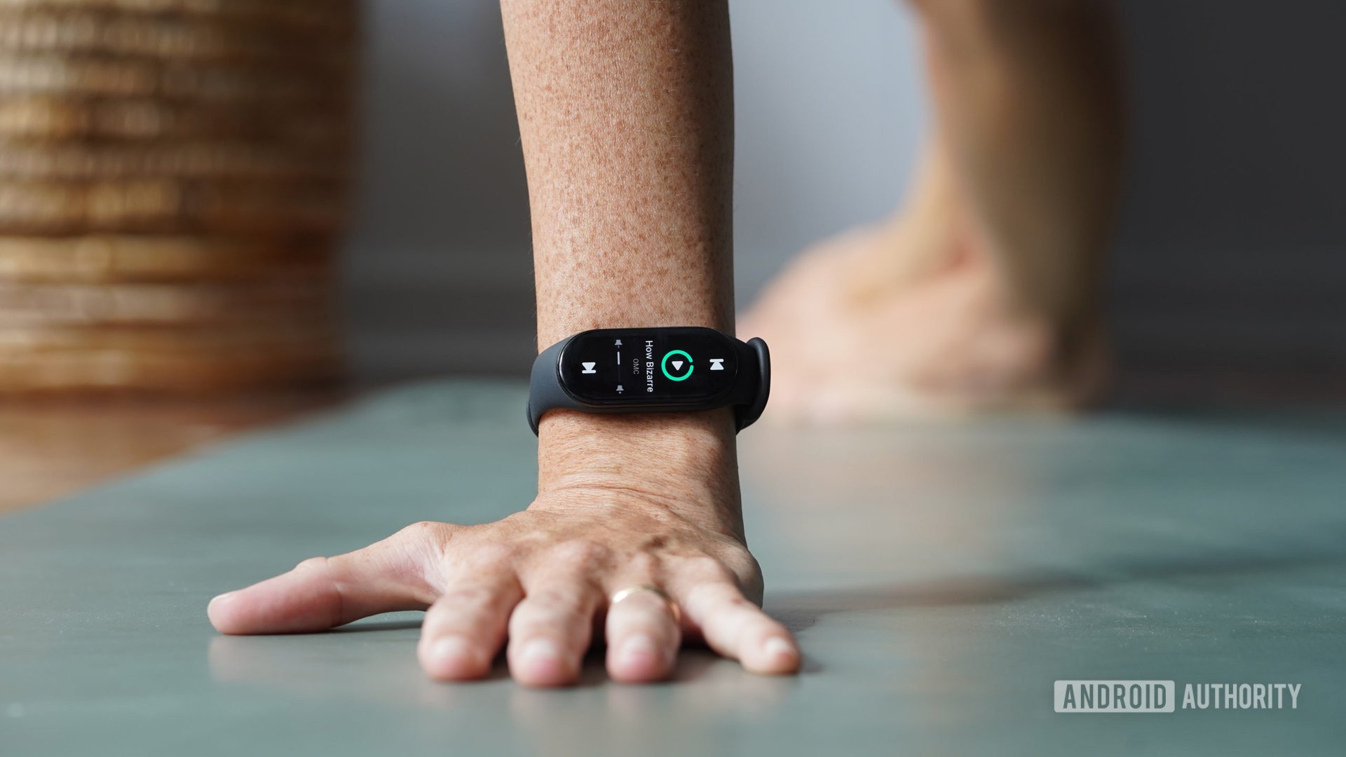 A Xiaomi Mi Band 7 user controls their music from their wrist during a yoga workout.