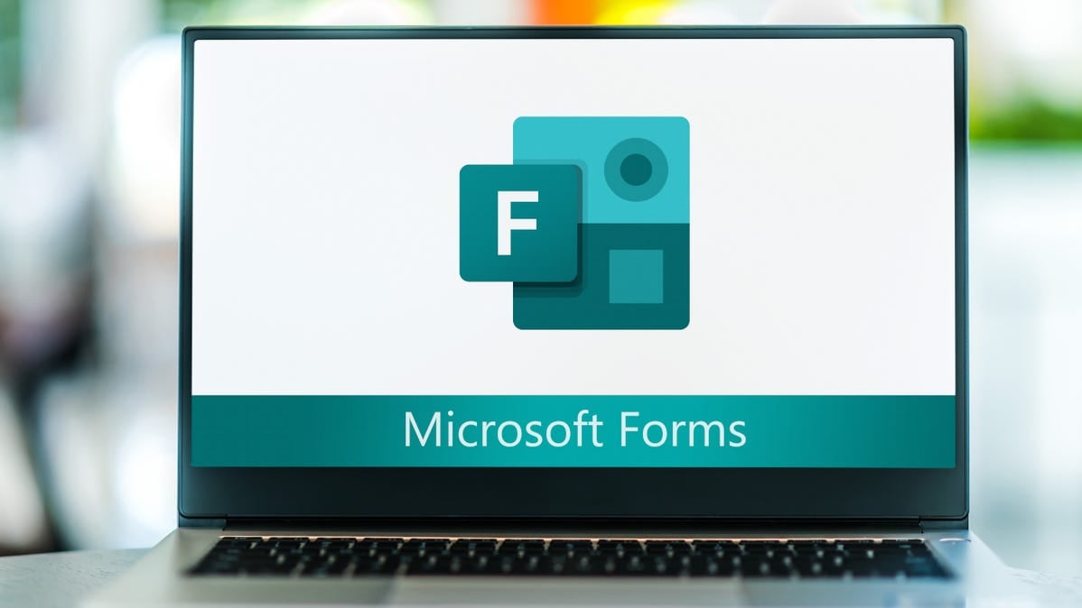A laptop screen showing the Microsoft Forms logo.