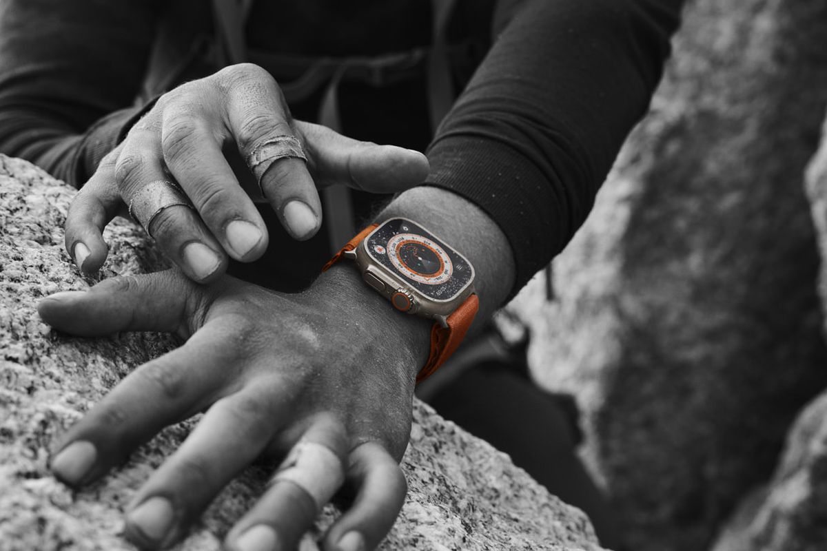 Black and white image of a rock climber wearing the Apple Watch Ultra.
