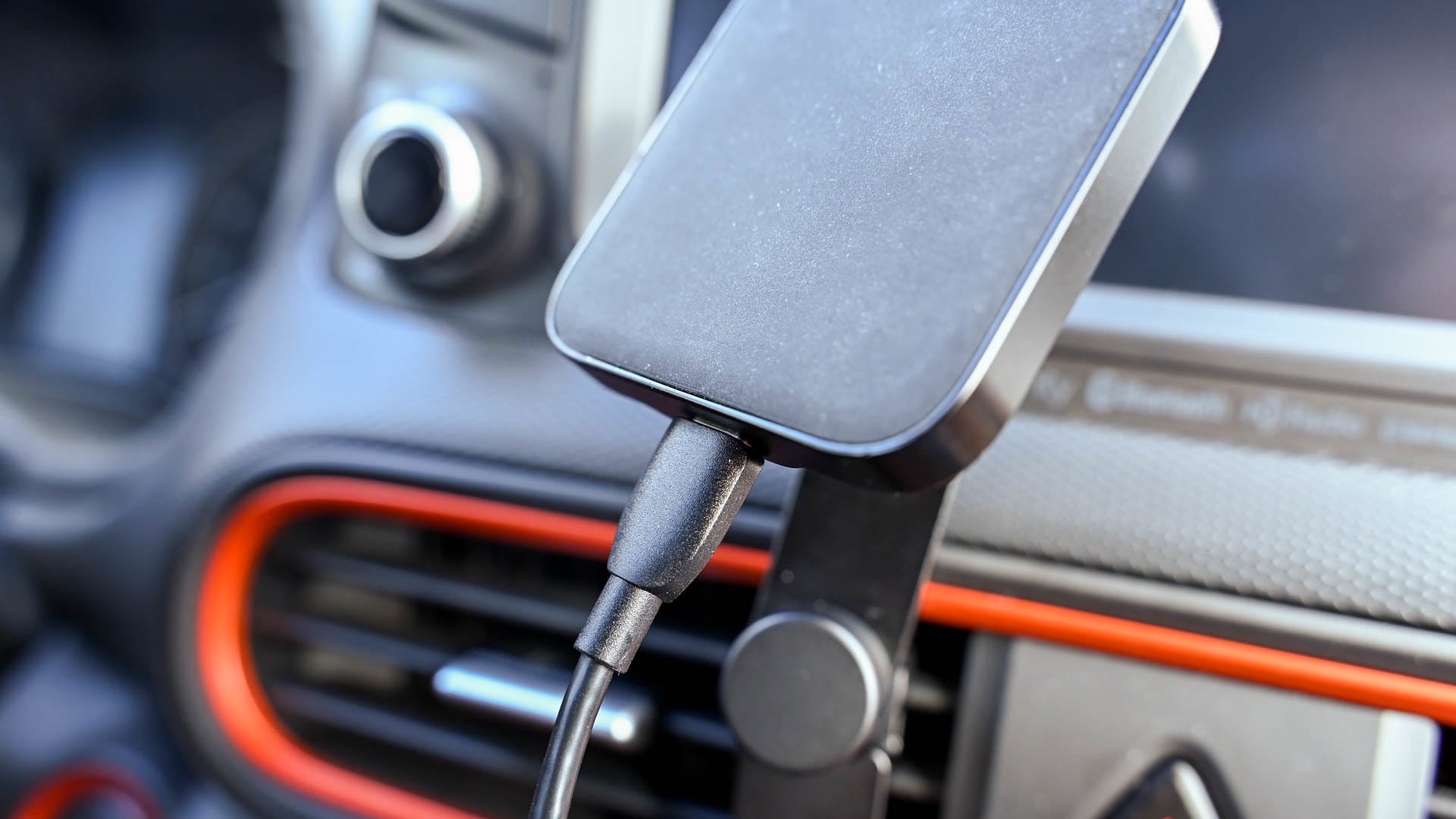 Peak Design wireless car vent mount charger and plug.